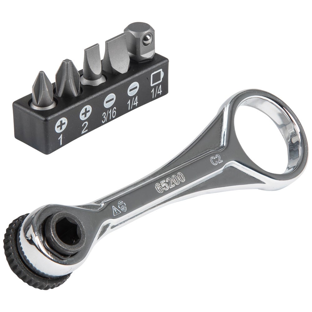 Klein Tools 65200 mini ratchet with a chrome finger-loop handle, next to a bit holder with Phillips and slotted bits and a socket adapter